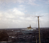 Behind USS Tripoli